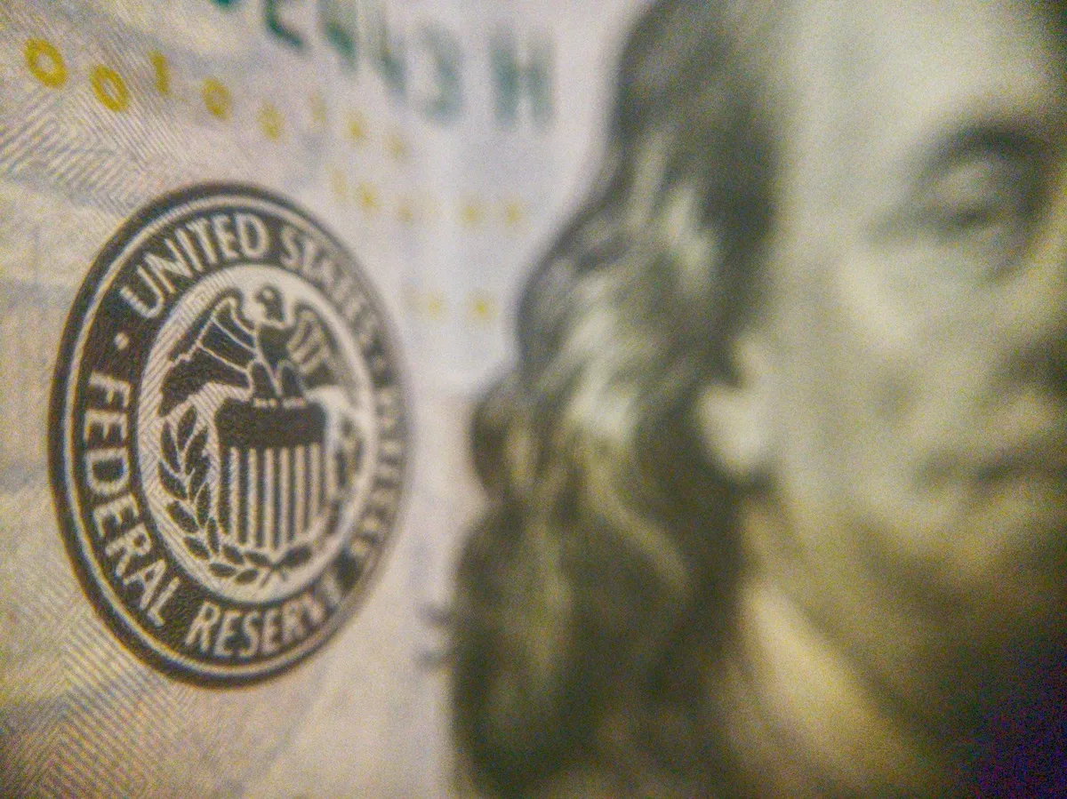 Federal Reserve logo highlighted on a U.S. banknote (joshua-hoehne/Unsplash)